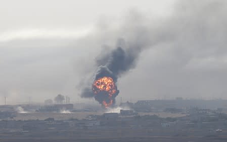 Explosion is seen over the Syrian town of Ras al-Ain as seen from the Turkish border town of Ceylanpinar