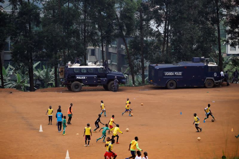 Ugandan police APC's are parked on a soccer field in Kampala