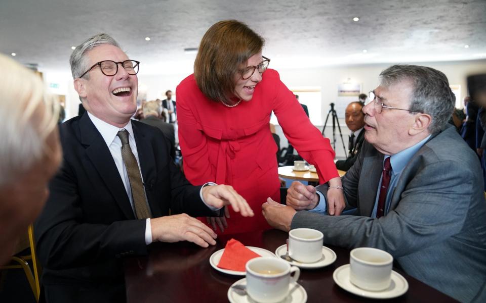 Sir Keir Starmer with Labour candidate Alex Baker (centre) during a visit to a veterans' coffee morning at Aldershot Town Football Club