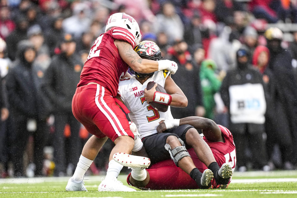 Wisconsin linebacker Kaden Johnson (52) and linebacker Maema Njongmeta (55) sack Maryland quarterback Taulia Tagovailoa (3) during the second half of an NCAA college football game Saturday, Nov. 5, 2022, in Madison, Wis. (AP Photo/Andy Manis)