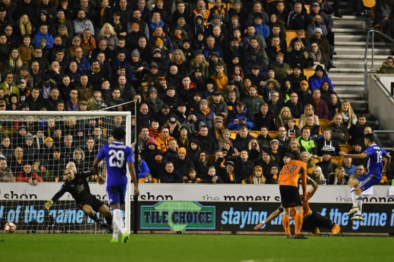 Chelsea's striker Diego Costa (R) shoots past Wolverhampton Wanderers' goalkeeper Carl Ikeme (L) to score their second goal on February 18, 2017