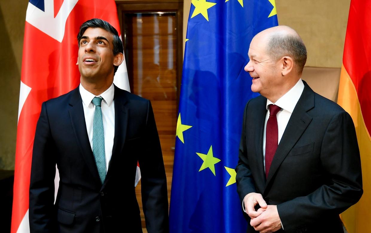 Britain's Prime Minister Rishi Sunak (L) speaks with German Chancellor Olaf Scholz during their bilateral meeting at the 59th Munich Security Conference on Feb 18, 2023 - Pool