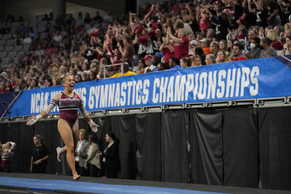 Oklahoma's Olivia Trautman celebrates after competing in the vault during the semifinals of the NCAA women's gymnastics championships Thursday, April 13, 2023, in Fort Worth, Texas. (AP Photo/Tony Gutierrez)