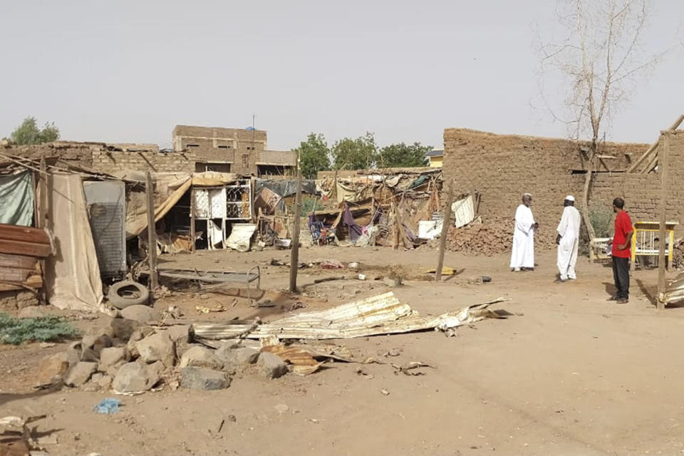 People check the rubble of their destroyed home after strikes at Allamat district in Khartoum, Sudan, Thursday, June 1, 2023. The White House says it's imposing sanctions against key defense companies and people who “perpetuate violence” in Sudan as the warring sides fail to abide by a cease-fire agreement in the northeastern African nation. (AP Photo)