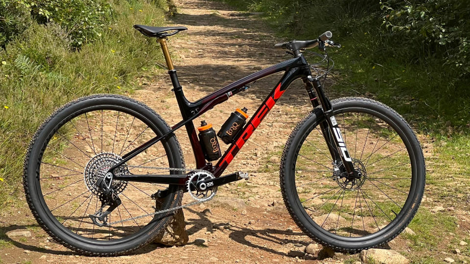  The new Trek Supercaliber viewed from the side on a trail 