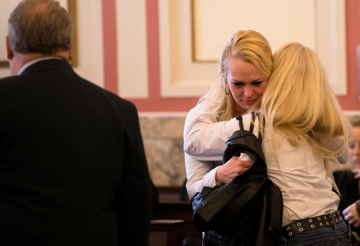 Samantha Davis is embraced before her sentencing hearing on Wednesday, May 1, 2019, in Hamilton County Common Pleas Court. Davis was found guilty of two counts of aggravated vehicular homicide and drug possession charges.