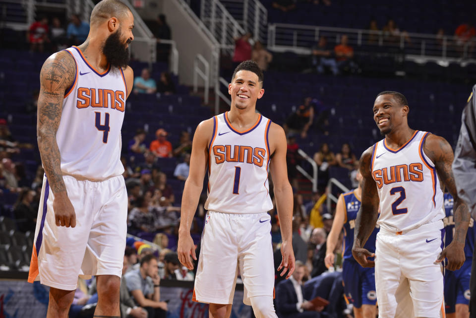 Tyson Chandler talks with Devin Booker, middle, and Eric Bledsoe during a preseason game. (Getty Images)
