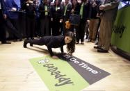 NASCAR driver Danica Patrick does pushups on the floor of the New York Stock Exchange, as her sponsor GoDaddy makes its initial public offering, in New York, April 1, 2015. REUTERS/Brendan McDermid