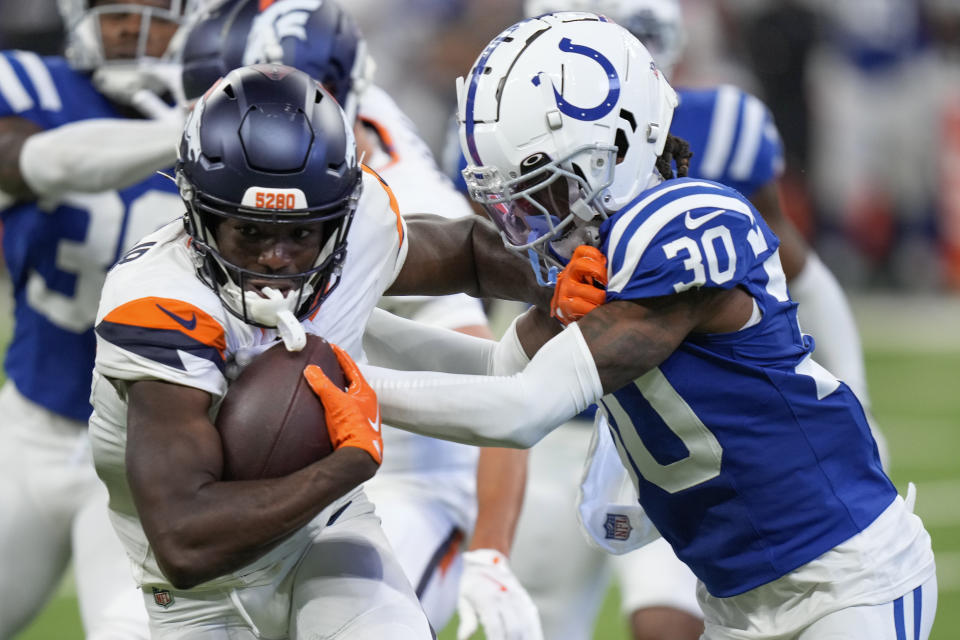 Denver Broncos wide receiver Marvin Mims Jr. (19) carries the ball agains Indianapolis Colts cornerback Jaylin Simpson (30) during the third quarter of a preseason NFL football game, Sunday, Aug. 11, 2024, in Westfield, Ind. (AP Photo/AJ Mast)