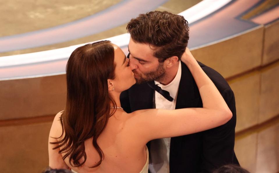 Emma Stone kissing her husband after her big win. REUTERS