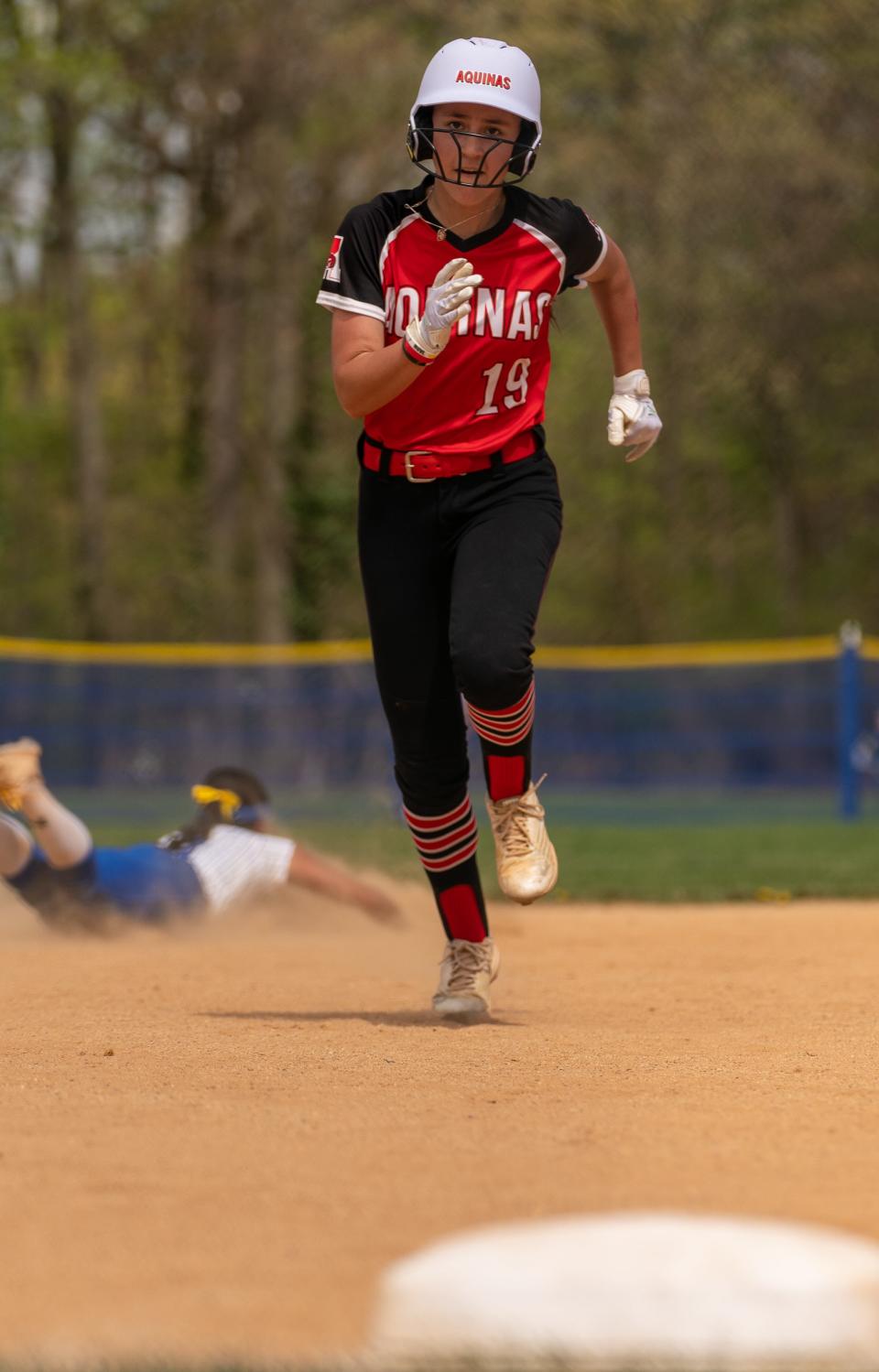 St. Thomas Aquinas' Alyssa Collins (19) runs for third base against Metuchen on Saturday, April 15 afternoon at the field at Metuchen High School.