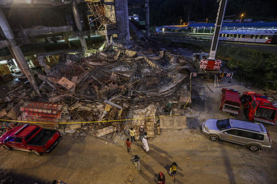 People are seen at the site of the Gombak Integrated Transport Terminal car park collapse in Kuala Lumpur May 23, 2019. — Picture by Firdaus Latif