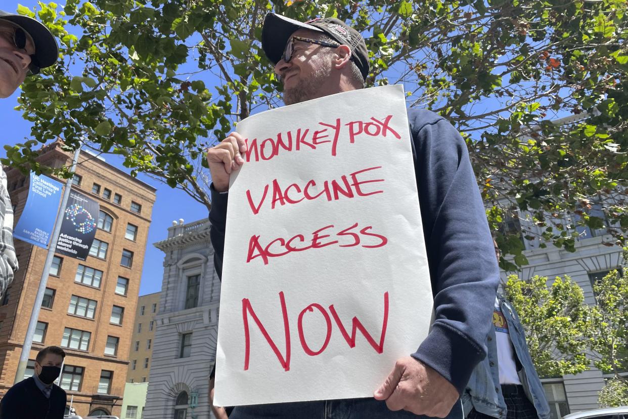 FILE - A man holds a sign urging increased access to the monkeypox vaccine during a protest in San Francisco, July 18, 2022. On Tuesday, August 9, 2022, U.S. health officials authorized a new monkeypox vaccination strategy designed to stretch limited supplies by allowing health professionals to vaccinate up to five people — instead of one — with each vial. 