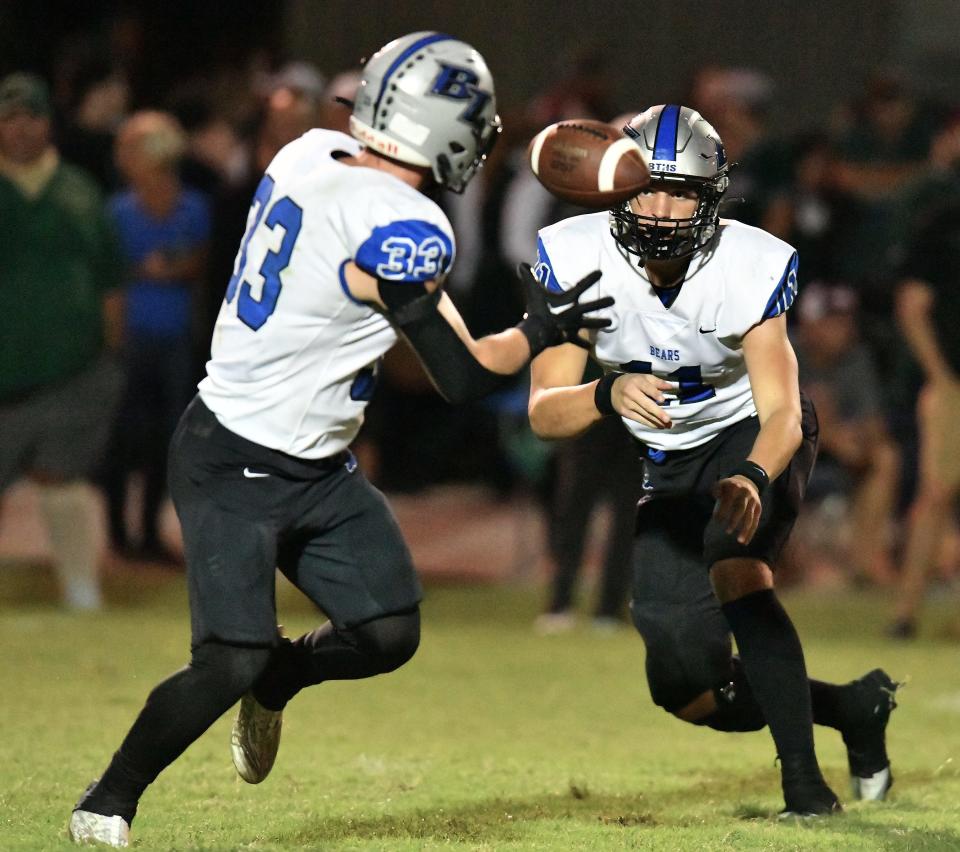 Bartram Trail's Laython Biddle (33) takes a pitch from quarterback Riley Trujillo in a Sept. 29 game. The senior running back is nearing 2,000 yards rushing for the 2023 season.