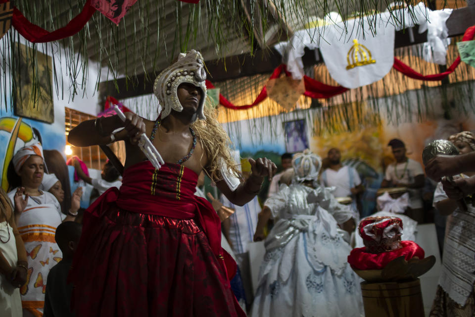 A man in trance dances during a Candomble religious ceremony at the Ile Ase Yoba temple in Seropédica, Rio de Janeiro state, Brazil, Sunday, Oct. 31, 2020. As Portuguese colonists brought African slaves to Brazil, the enslaved men and women developed blends of their traditional religions with Catholicism, which today include Candomble, Umbanda and Omoloko, and are practiced by a tiny minority. (AP Photo/Bruna Prado)