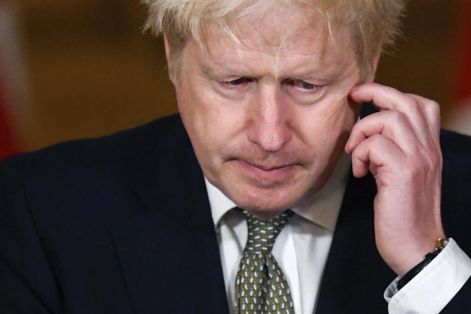 Britain's Prime Minister Boris Johnson gestures, during a coronavirus briefing in Downing Street, London, Monday, Oct. 12, 2020. (Toby Melville/Pool Photo via AP)