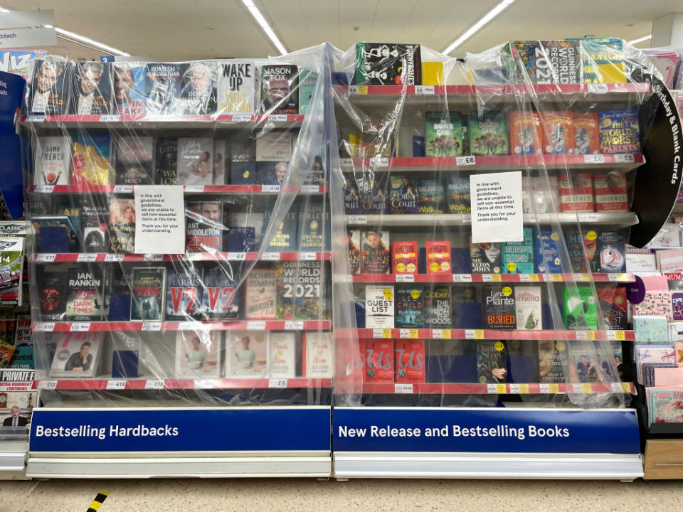 Shelves of  books covered in plastic sheeting in a Tesco store in Penarth, Wales. Source: Getty