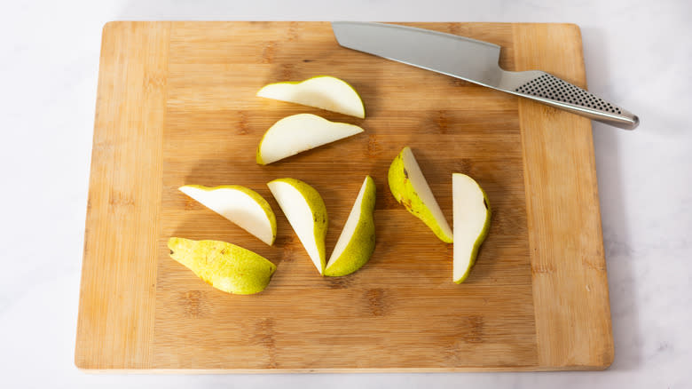 sliced pears on wood cutting board 