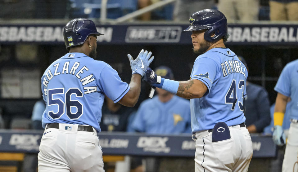 Tampa Bay Rays' Harold Ramirez (43) congratulates Randy Arozarena (56) after Arozarena's two-run home run off Baltimore Orioles starter Jordan Lyles during the first inning of a baseball game Sunday, July 17, 2022, in St. Petersburg, Fla. (AP Photo/Steve Nesius)