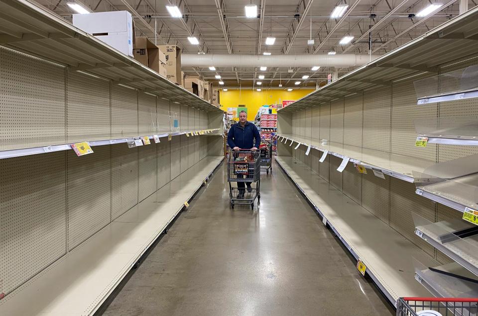 Customers at grocery chain HEB in Austin look for products among increasingly empty shelves as the city responds to concerns of the spread of coronavirus on March 13.