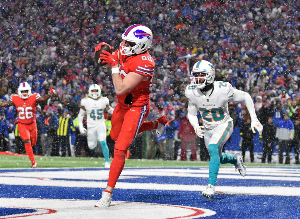 Dec 17, 2022; Orchard Park, New York, USA; Buffalo Bills tight end Dawson Knox (88) catches a touchdown pass against Miami Dolphins cornerback Justin Bethel (20) in the fourth quarter at Highmark Stadium. Mandatory Credit: Mark Konezny-USA TODAY Sports