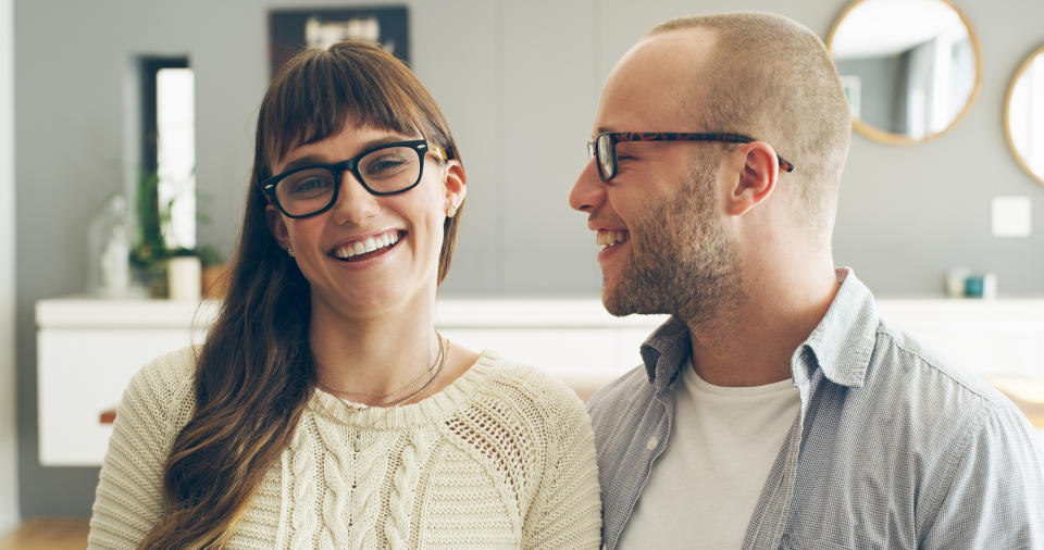 Cropped shot of an affectionate young woman smiling while spending time with her husband indoors at home