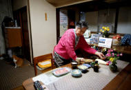 Royal aficionado Fumiko Shirataki, 78, prepares her dinner at her home in Kawasaki, Japan, April 21, 2019. REUTERS/Issei Kato