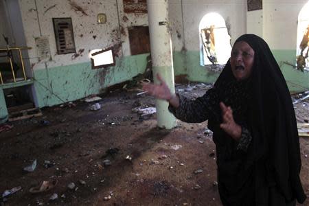 A woman reacts inside a Sunni mosque after two roadside bombs attacks on Sunni Muslim worshippers following Friday prayers in Baquba, around 65 km (40 miles) northeast of the capital Baghdad, September 13, 2013. REUTERS/Mohammed Adnan