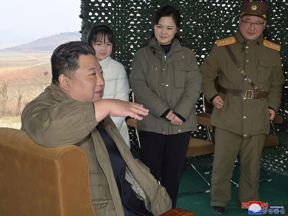 This photo provided on Nov. 19, 2022, by the North Korean government shows its leader Kim Jong Un, front, speaks, accompanied by his wife Ri Sol Ju, second from right, and his daughter, as Kim inspects the test firing of what it says a Hwasong-17 intercontinental ballistic missile, at Pyongyang International Airport in Pyongyang, North Korea, Friday, Nov. 18, 2022.