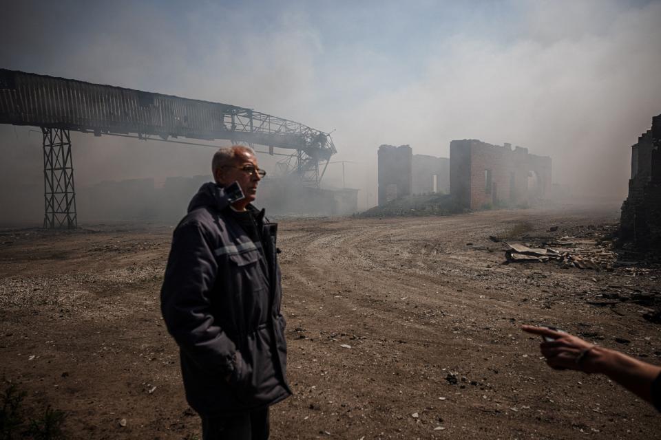 Smoke rises from burning storage buildings containing agricultural products after shelling by Russian forces in  Orikhiv, Ukraine, on May 11, 2022.