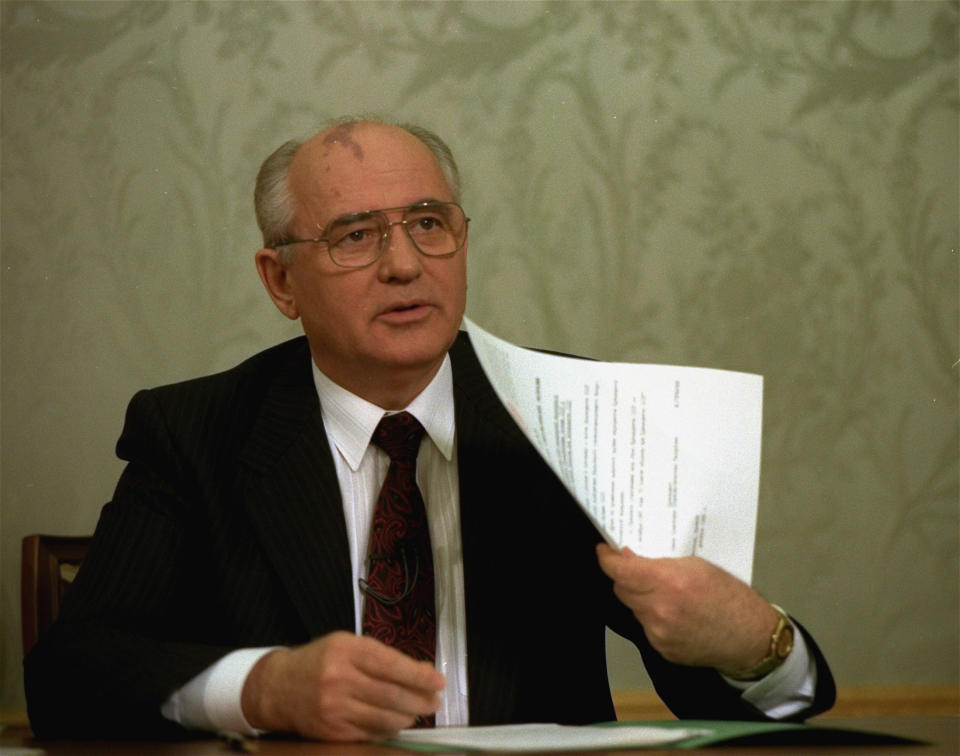 FILE - Mikhail Gorbachev flashes the decree relinquishing control of nuclear weapons to Russian President Boris Yeltsin after its signature at the Kremlin in Moscow on Dec. 25, 1991, drawing a line under more than 74 years of Soviet history. By the fall of 1991, however, deepening economic woes and secessionist bids by Soviet republics had made the collapse all but inevitable. The failed August 1991 coup by the Communist old guard was a major catalyst, dramatically eroding Gorbachev’s authority and encouraging more republics to seek independence. (AP Photo/Liu Heung Shing, File)