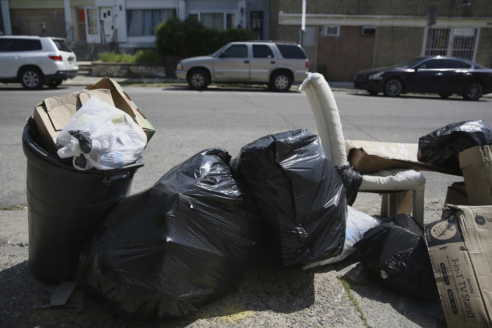 FILE— Bags of garbage sit along the street before being picked up in Philadelphia's Ogontz section in this file photo from May 13, 2020. Households are generating more trash as people stay home during the coronavirus pandemic. (Tim Tai/The Philadelphia Inquirer via AP, File)
