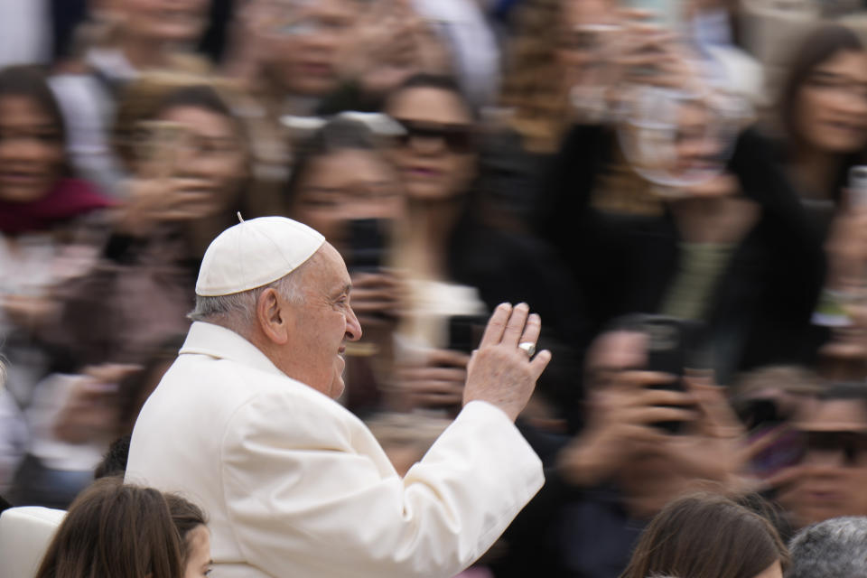 Pope Francis waves faithful as he arrives for his weekly general audience in St. Peter's Square, at the Vatican, Wednesday, April 3, 2024. (AP Photo/Alessandra Tarantino)