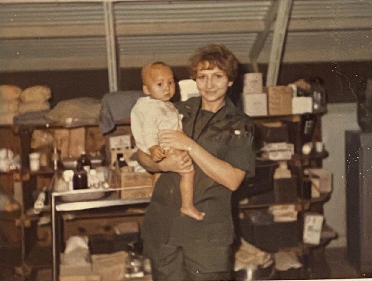 Anna Kathryn Tolbert holds a toddler in Vietnam.