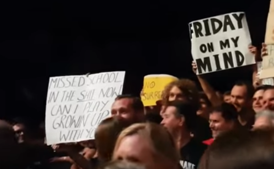 The sign [far left] the young fan was waving to get Springsteen's attention (YouTube)