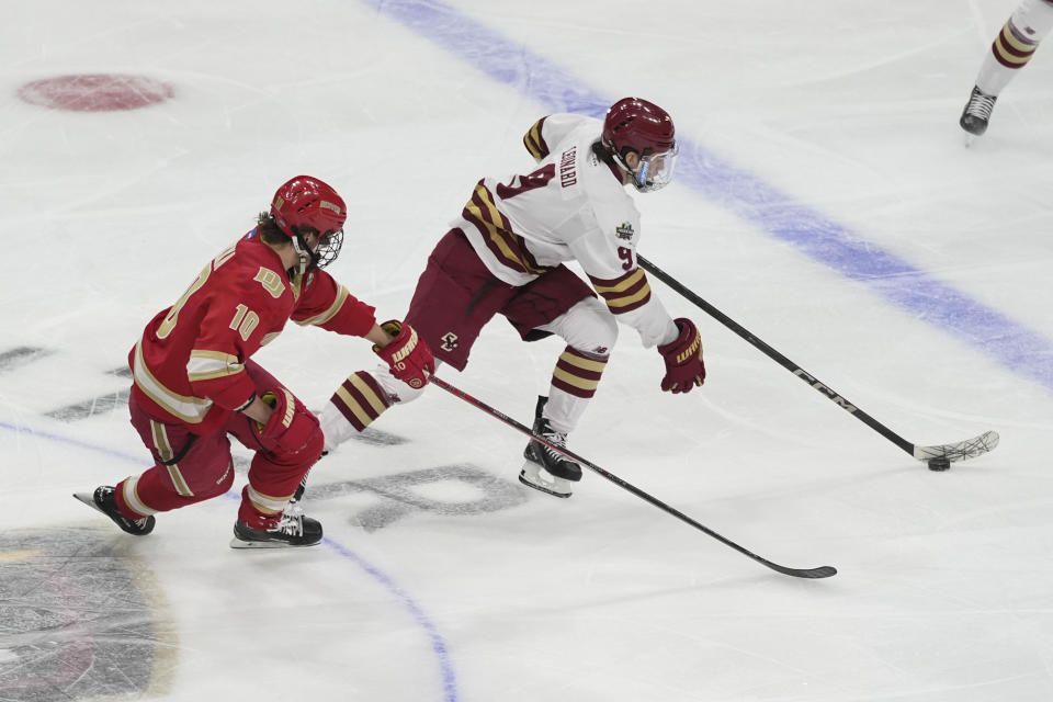 Boston College forward Ryan Leonard skates past Denver forward Miko Matikka (10) during the first period in the championship game of the Frozen Four NCAA college hockey tournament Saturday, April 13, 2024, in St. Paul, Minn. (AP Photo/Abbie Parr)