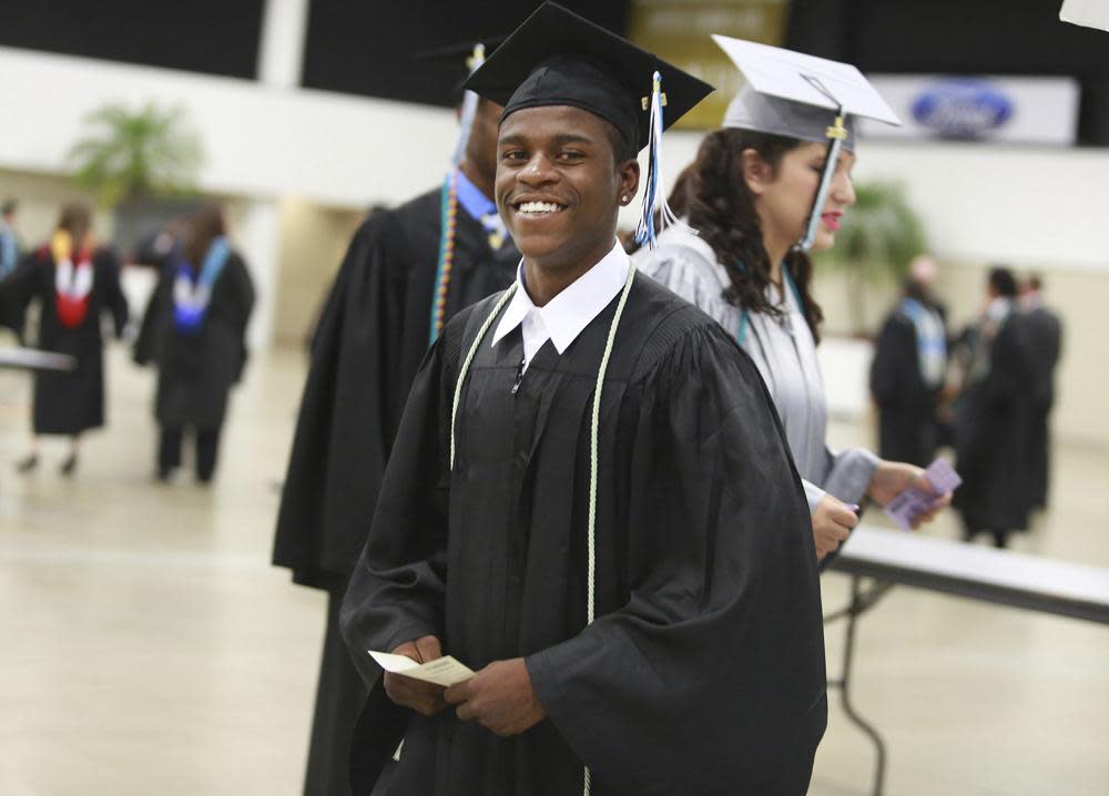 This May 23, 2016 file photo shows Royal Palm Beach High School student Damon Weaver during his high school graduation in West Palm Beach, Fla. Weaver who gained national acclaim when he interviewed President Barack Obama at the White House in 2009 has died of natural causes, his family says. Weaver was 23 when he died May 1, 2021 his sister, Candace Hardy, told the Palm Beach Post. (Carline Jean/South Florida Sun-Sentinel via AP)