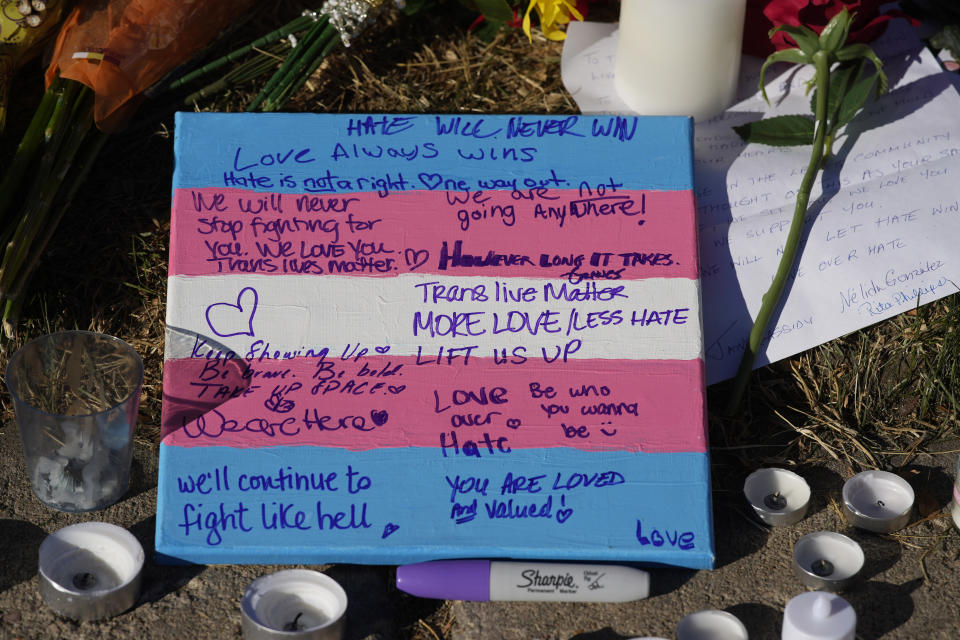 Messages are written on a sign amid the makeshift memorial to honor the victims of a weekend mass shooting at a nearby gay nightclub on Tuesday, Nov. 22, 2022, in Colorado Springs, Colo. Anderson Lee Aldrich opened fire at Club Q, in which five people were killed and others suffered gunshot wounds before patrons tackled and beat the suspect into submission. (AP Photo/David Zalubowski)