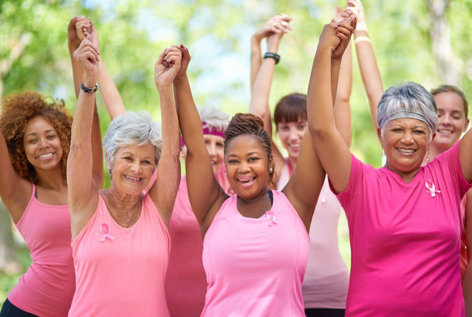 Portrait of a group of enthusiastic woman taking part in a fitness event to raise awareness for breast cancer.