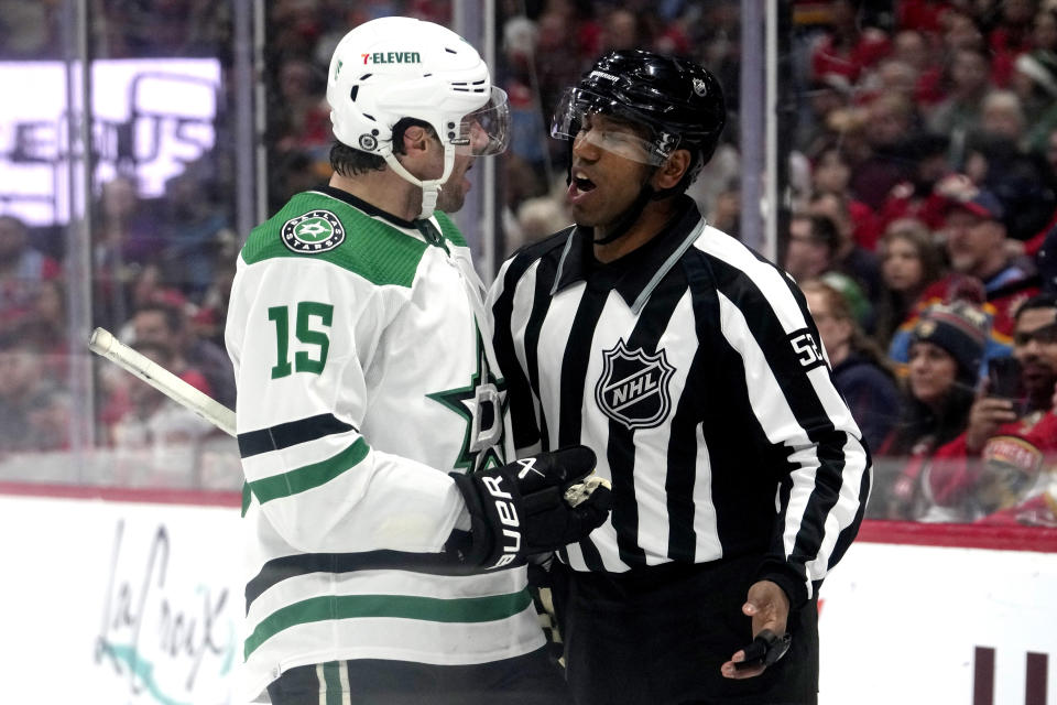 Dallas Stars center Craig Smith (15) talks with official Shandor Alphonso, right, during the first period of an NHL hockey game against the Florida Panthers, Wednesday, Dec. 6, 2023, in Sunrise, Fla. (AP Photo/Lynne Sladky)