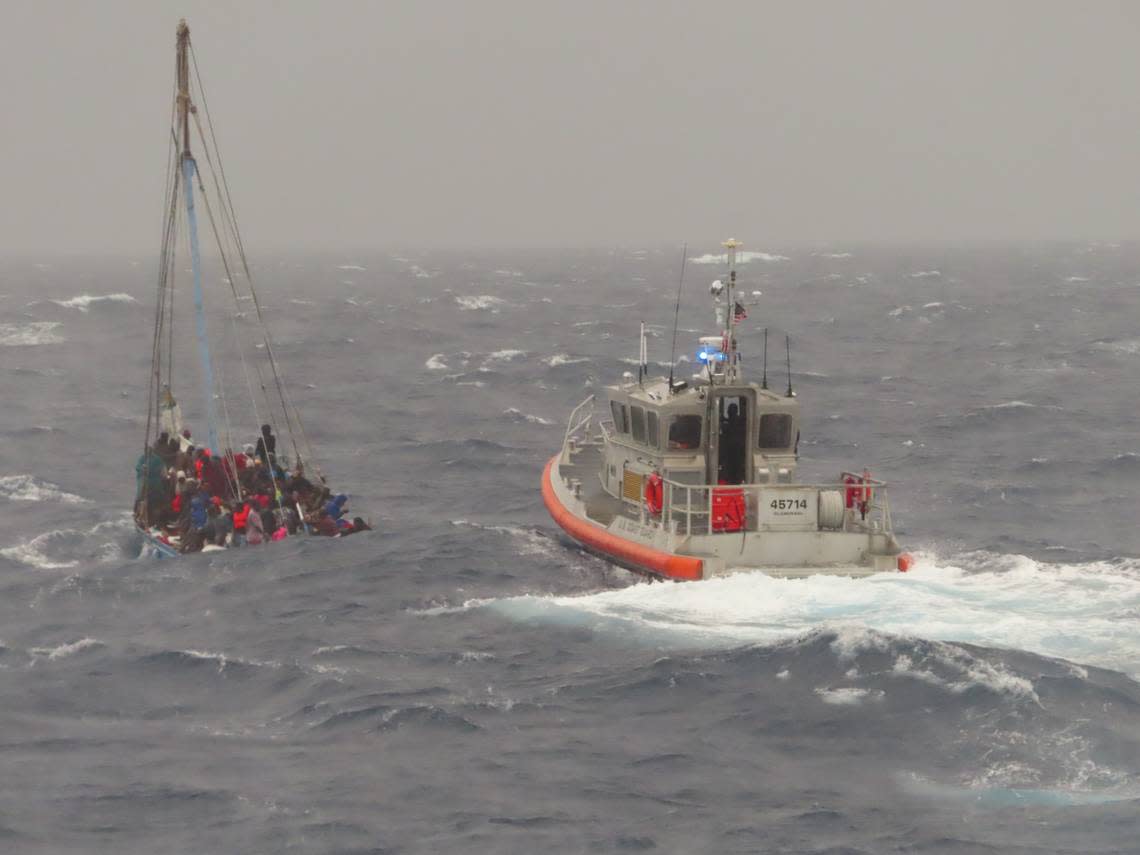 A U.S. Coast Guard boat approaches a sailing vessel packed with migrants law enforcement sources say are from Haiti off the coast of Key Largo Monday, Nov. 21, 2022.