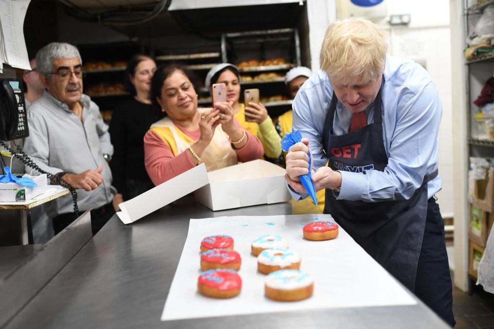 Boris Johnson in north London where he made 'get Brexit done' doughnuts (PA)