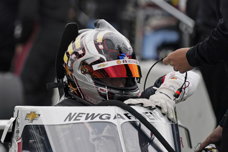 Josef Newgarden climbs into his car during testing at the Indianapolis Motor Speedway, Thursday, April 8, 2021, in Indianapolis. (AP Photo/Darron Cummings)