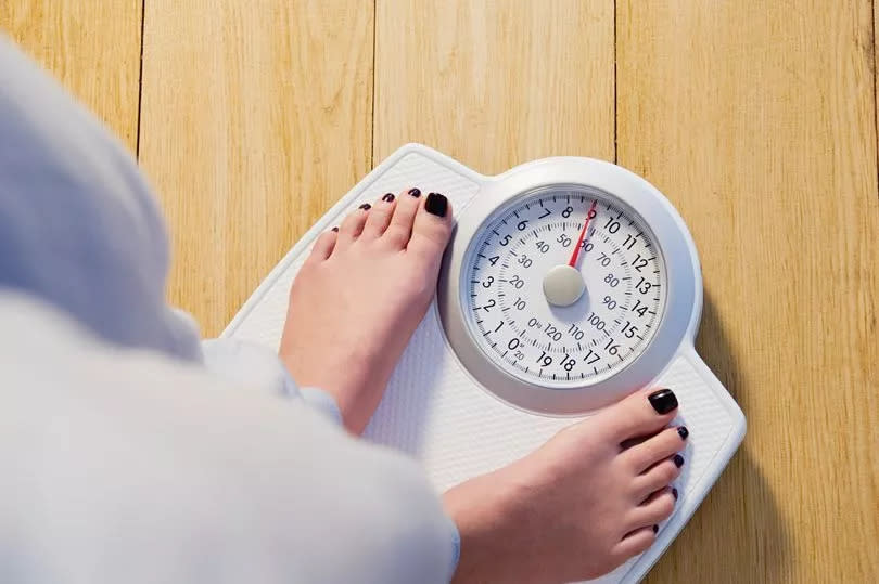 Close-up of woman on weighing scales