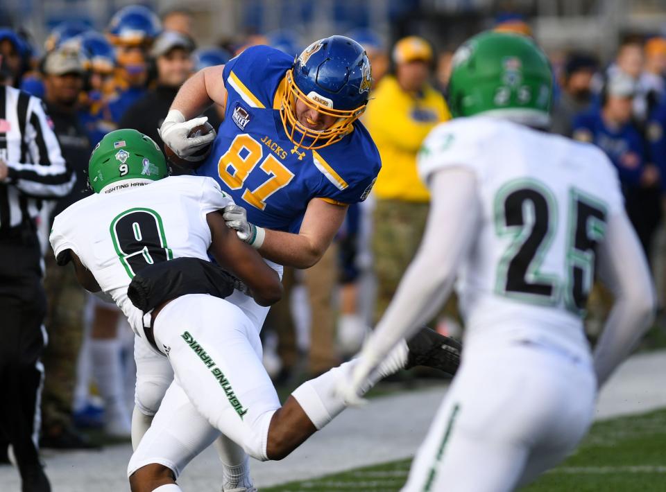 South Dakota State's Zach Heins is tackled out of bounds by North Dakota's Marcus Vaughn-Jones on Saturday, November 20, 2021, at Dana J. Dykhouse Stadium in Brookings.