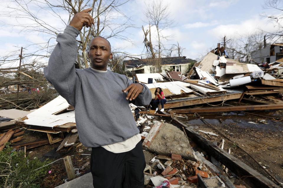 Darryl McMorris, recalls how the outside debris flew in his face moments before he managed to secure his wife and two daughters in the children's bedroom as a tornado bore down on the residence, Saturday, Jan. 21, 2017. The house was moved several feet from its foundation and was completely destroyed, but the four were left uninjured. (AP Photo/Rogelio V. Solis)