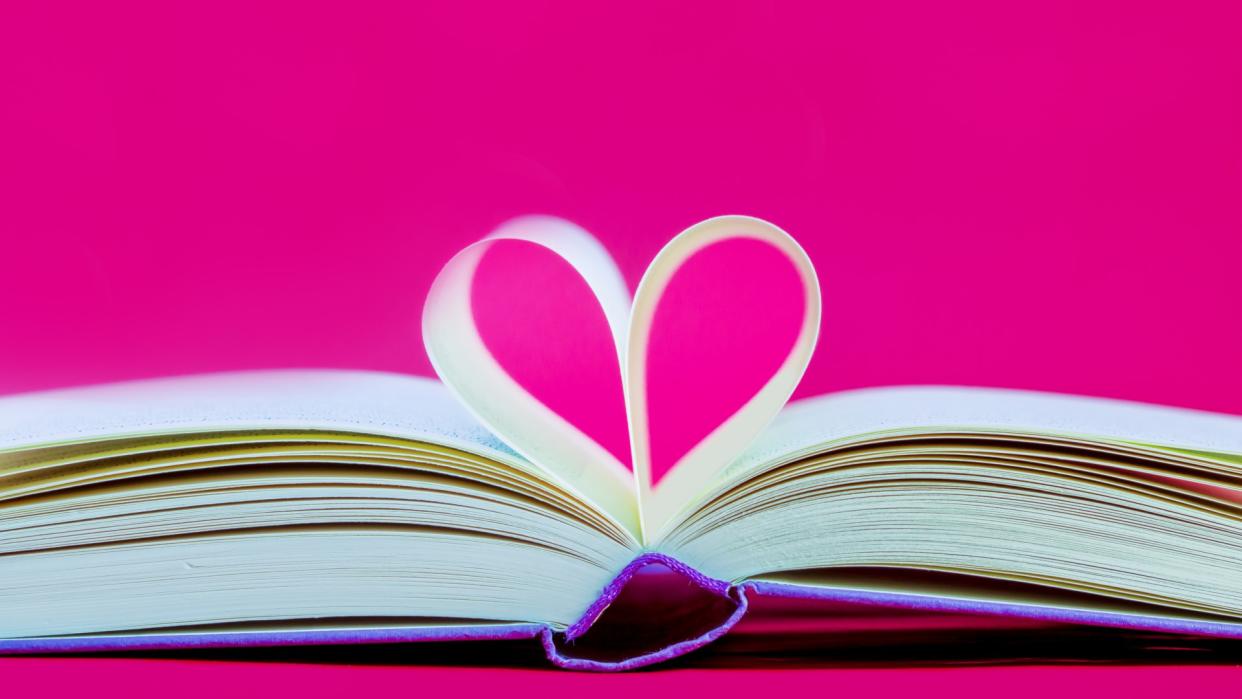  Opened book, pages shaped to form a heart. 