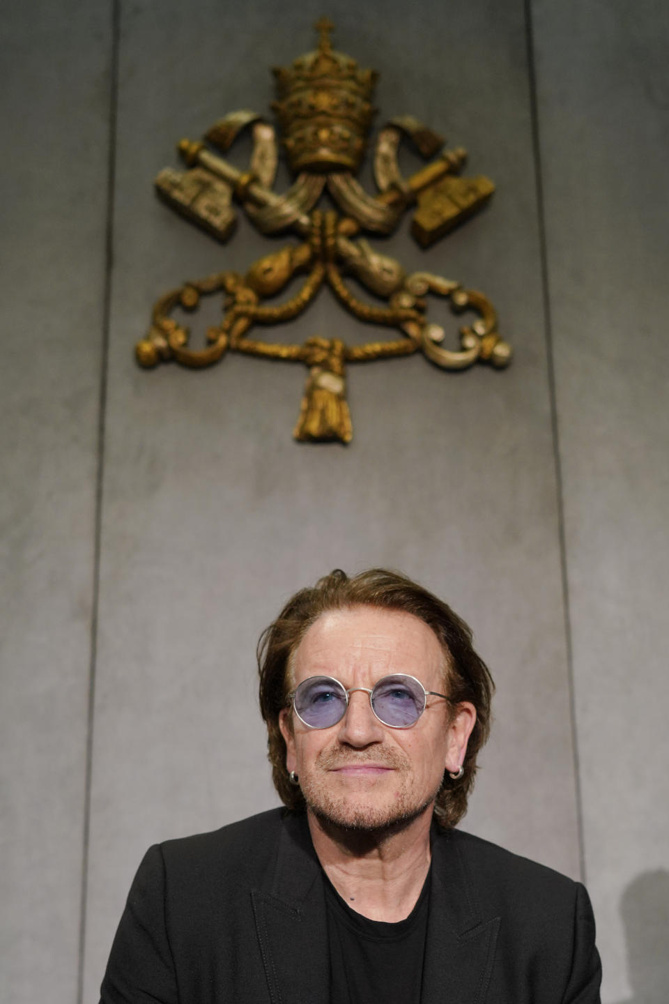 U2 rock band frontman Bono Vox talks to reporters during a press conference he held at the end of a meeting with Pope Francis, at the Vatican, Wednesday, Sept. 19, 2018. (AP Photo/Andrew Medichini)