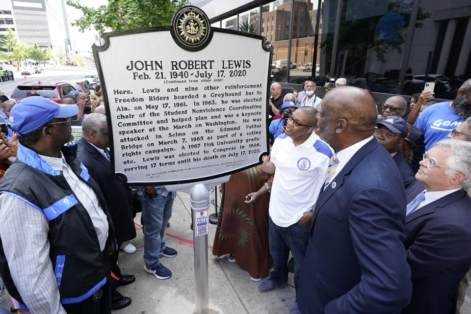 People look at a new historical marker remembering former Rep. John Lewis after it was unveiled Friday, July 16, 2021, in Nashville, Tenn. Earlier this year, Nashville's Metro Council renamed a large portion of Fifth Avenue to Rep. John Lewis Way. (AP Photo/Mark Humphrey)