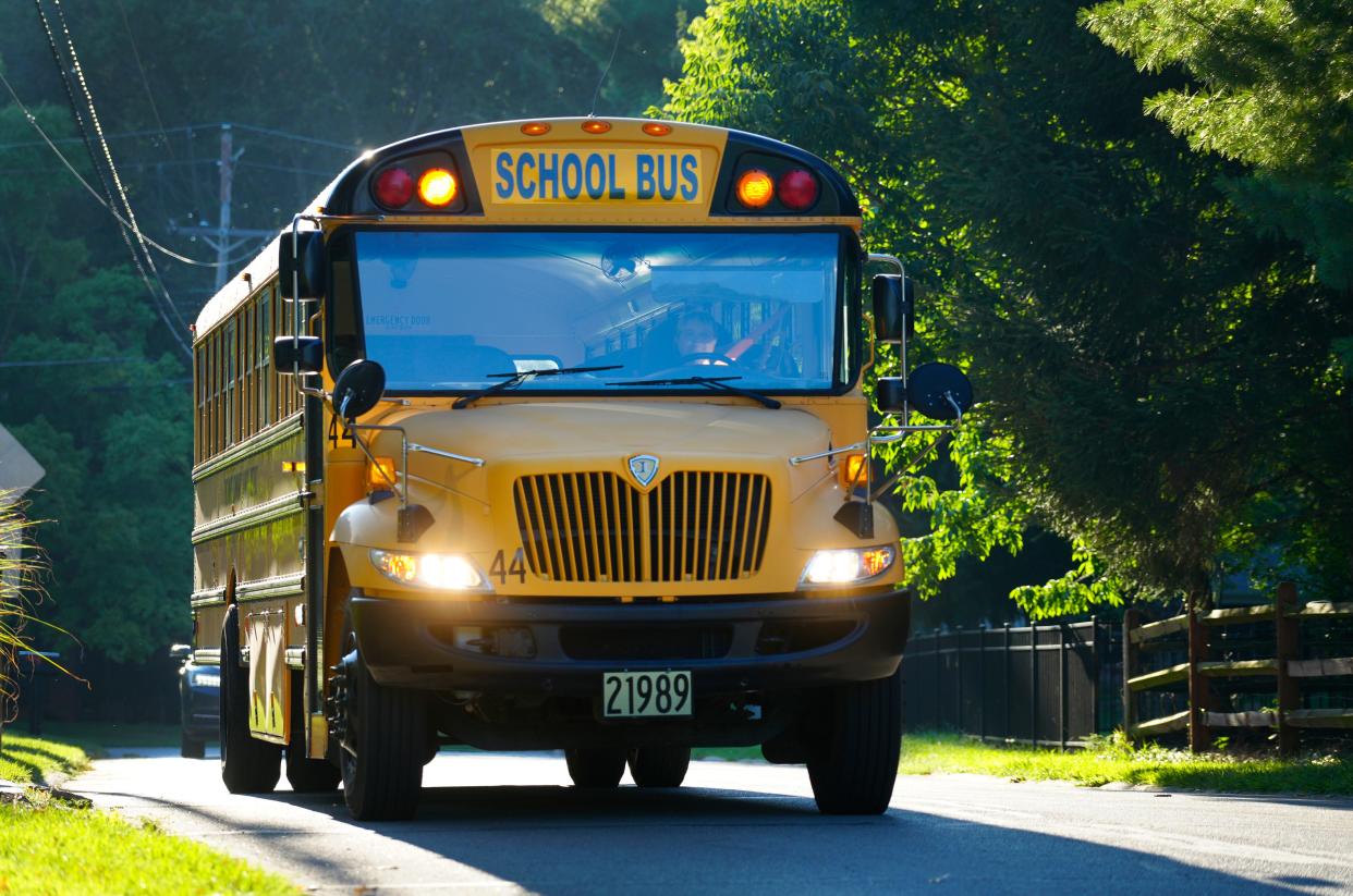 A Sycamore Community school bus picks up kids in a Blue Ash neighborhood for the first day of school at Blue Ash Elementary, Monday, August 28, 2023.